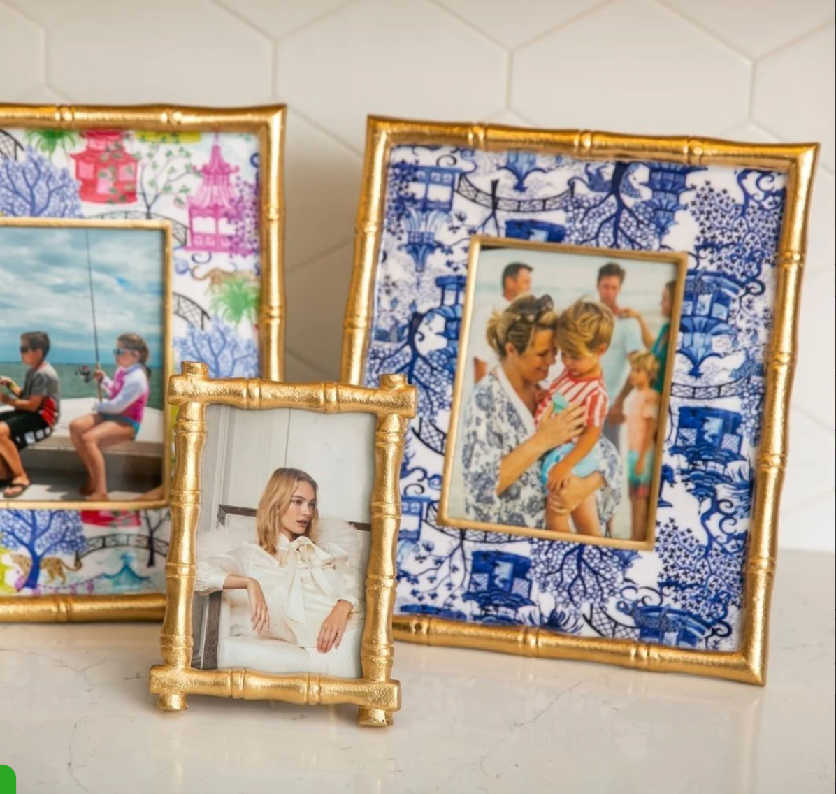 Collection of decorative picture frames with different designs on a tiled wall.