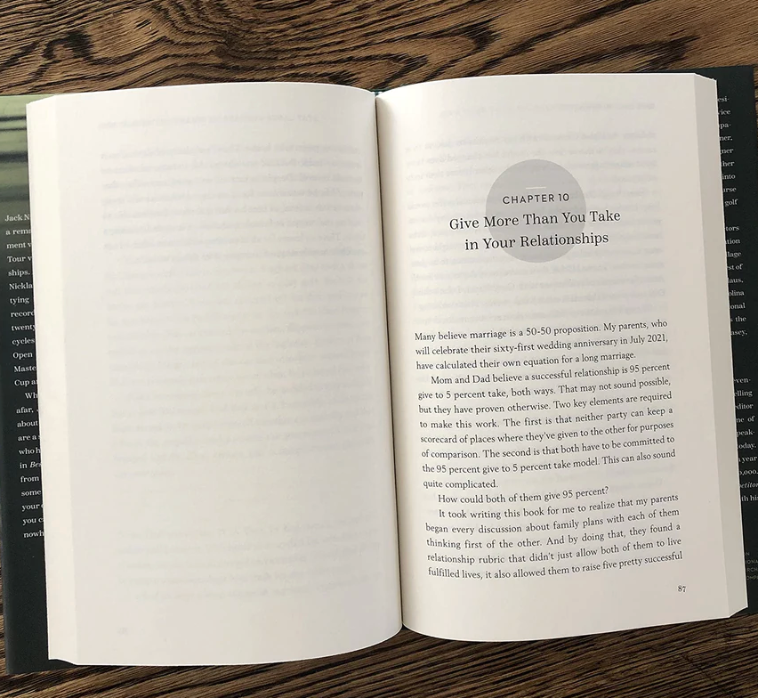 Open book on a wooden surface with text visible