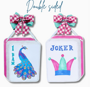 Two mahjong Tiles with bow and copy that says "double sided" on white background