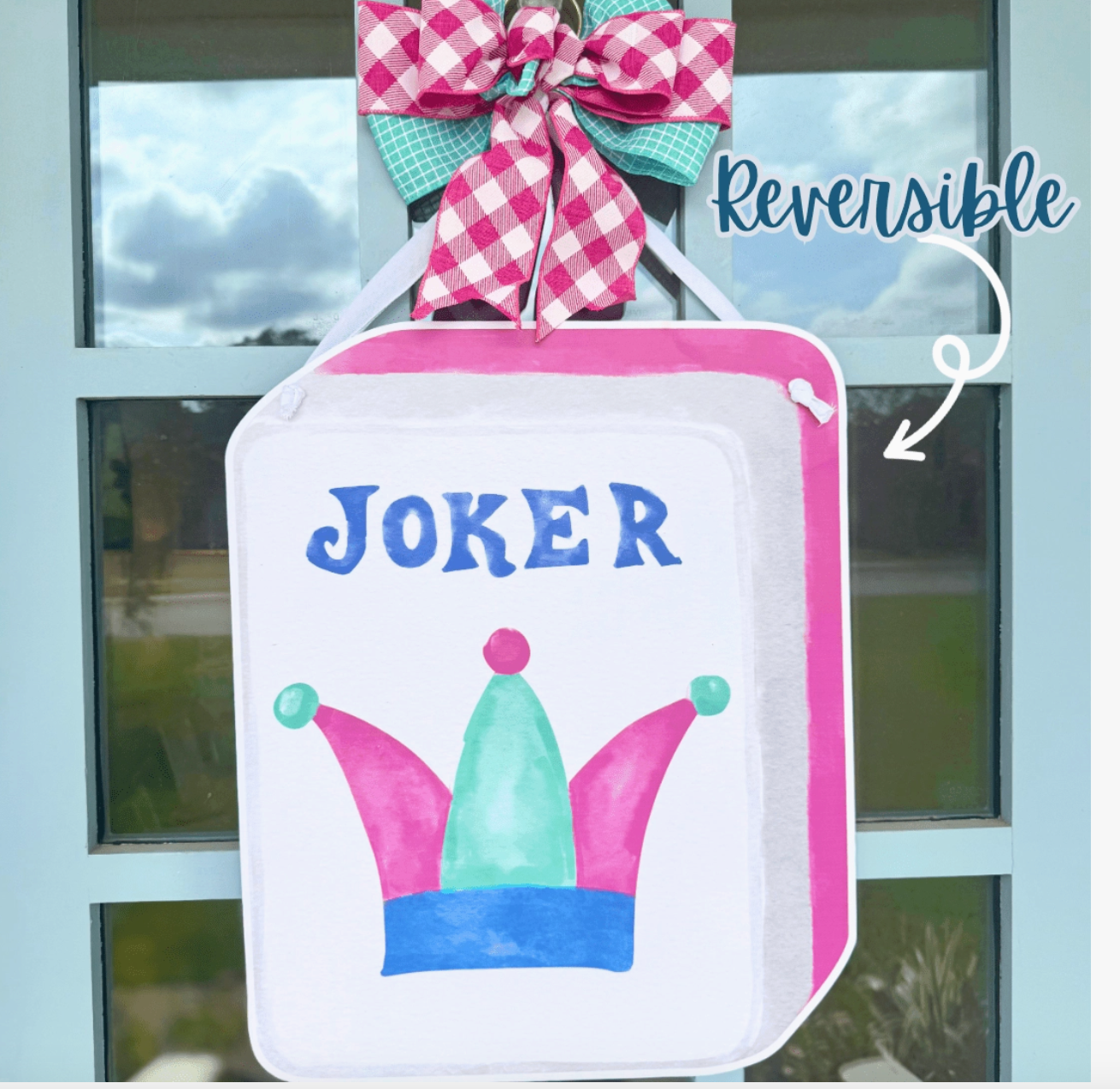 Joker mahjong Tile door hanger with bow and copy that says "reversible" hanging on blue door