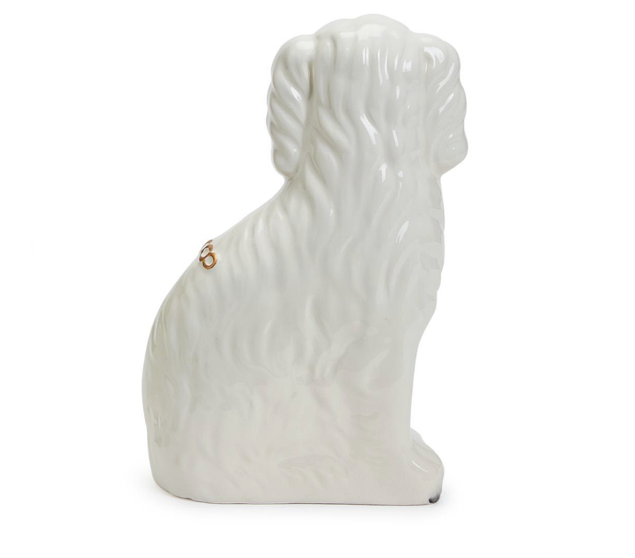 White ceramic dog sculpture on a white background