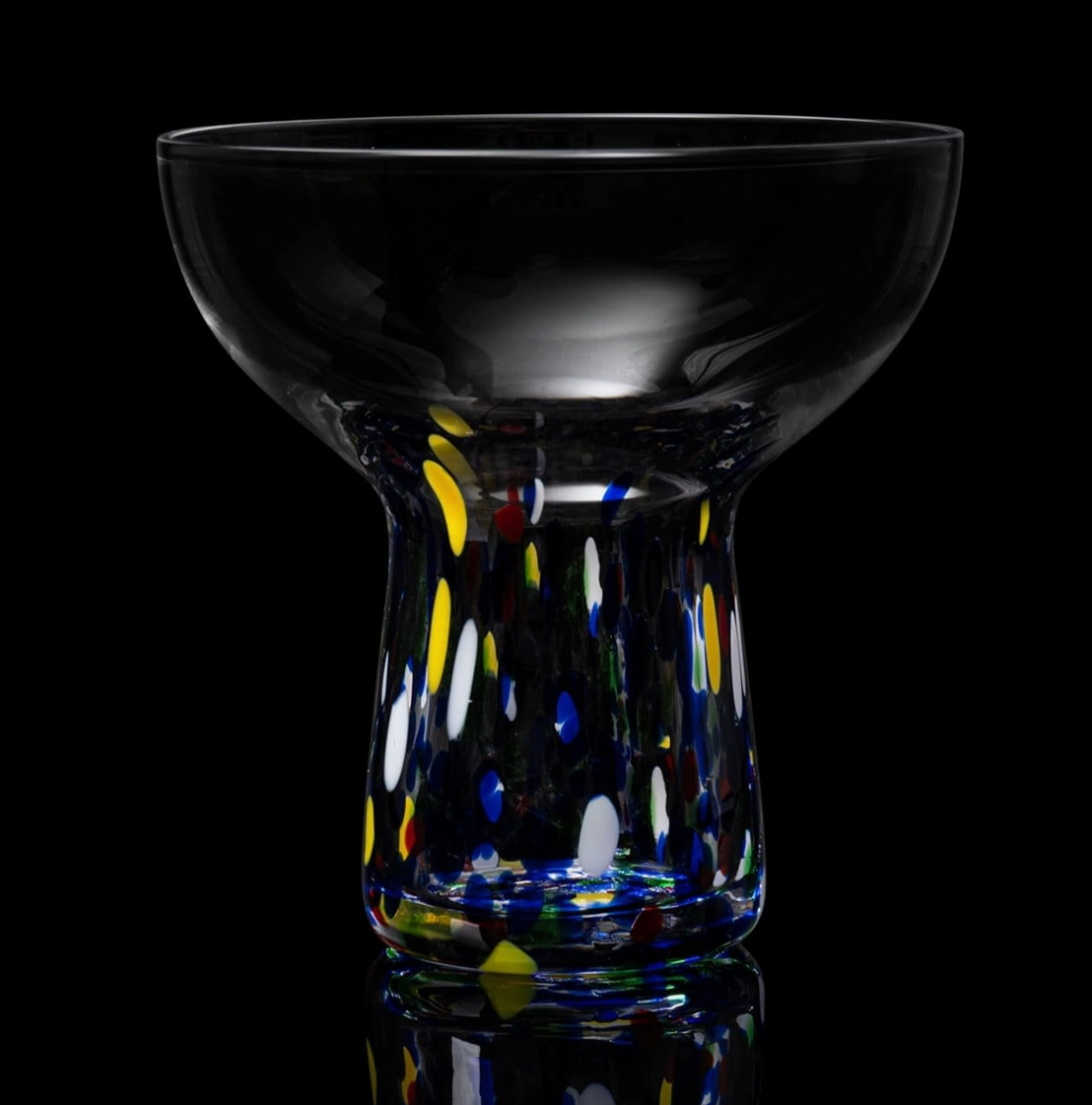 Confetti colorful stemmed glass with bowl top, multicolored dots on a black background