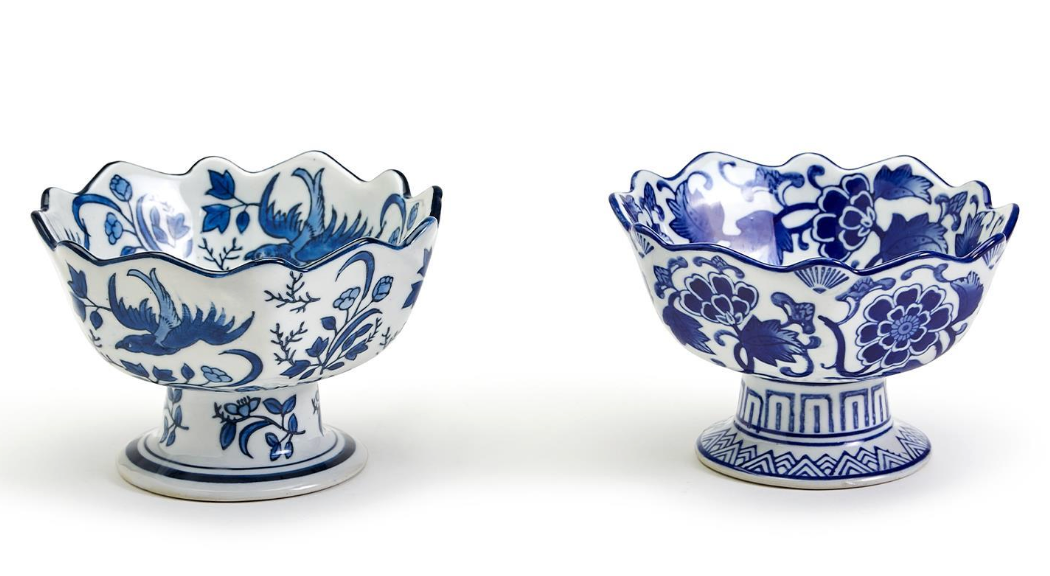 Two blue and white ceramic bowls with floral patterns on a white background