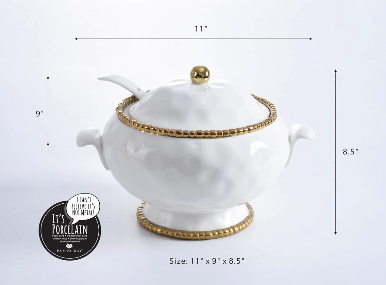 White ceramic and titanium Pampa Bay tureen, lid and spoon with gold accents on a light gray surface with measurements on a white background