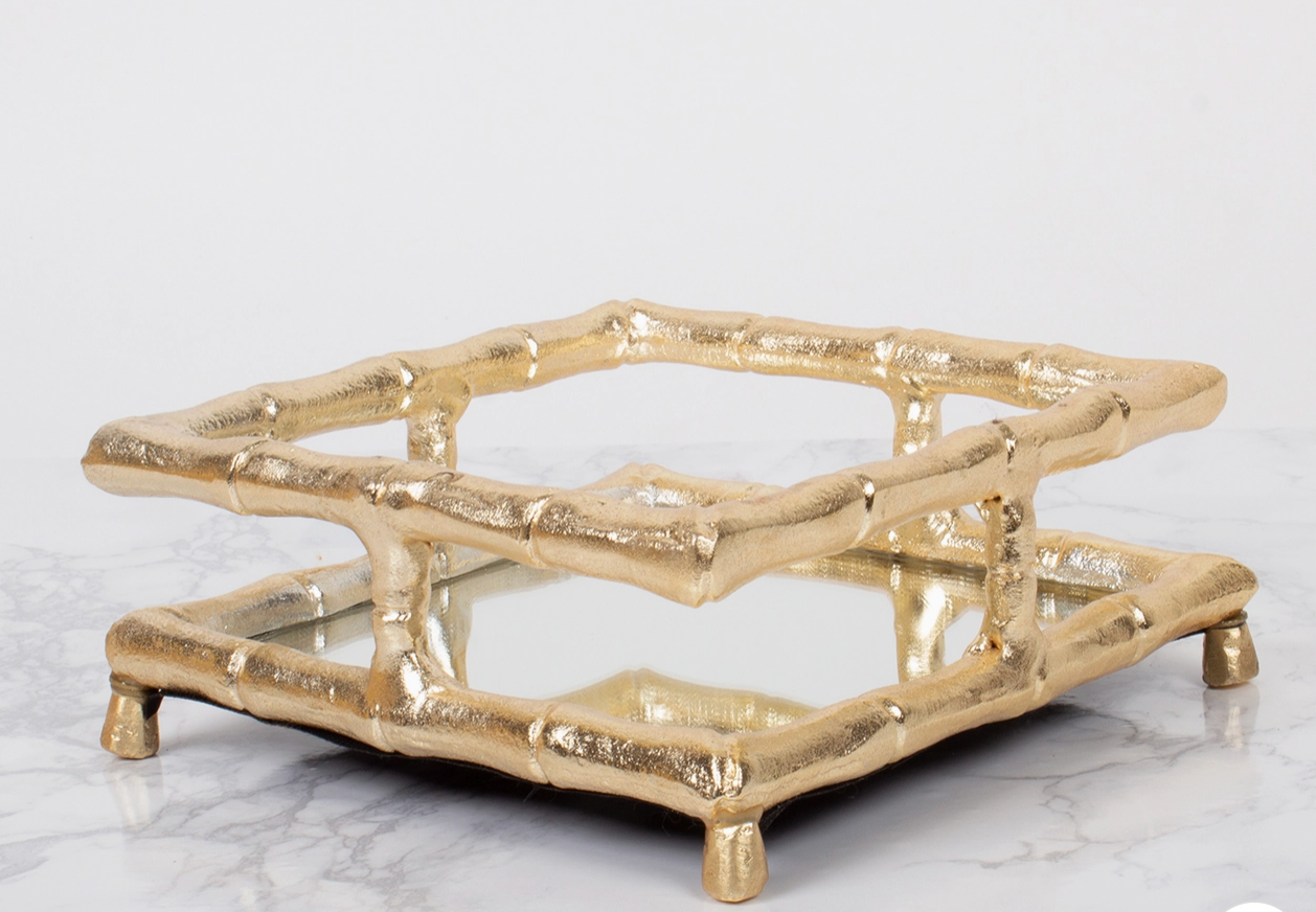 8 Oak Lane gold bamboo design cocktail napkin holder with mirrored bottom on marble surface 