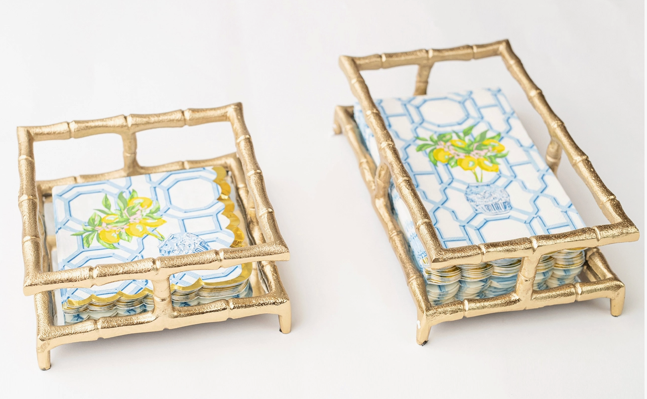 8 Oak Lane gold bamboo cocktail and guest napkin trays with blue and yellow napkins on a white background