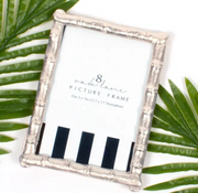 8 Oak Lane 5 x 7" Silver picture frame with black and white stripe on the picture insert on a white background with green leaves ith white background