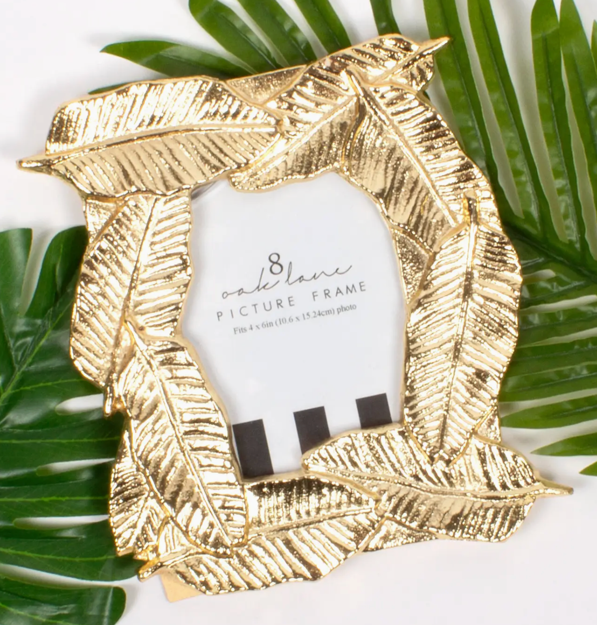 8 Oak Lane Gold banana leaf picture frame on a white background with green leaves