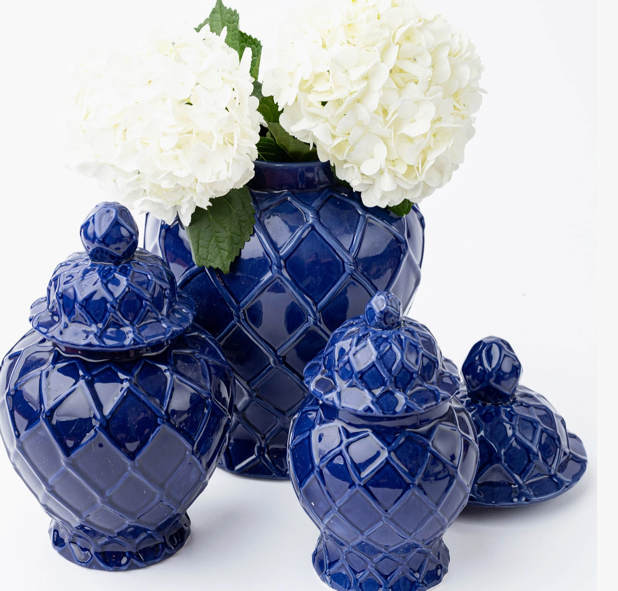 8 oak lane brand Set of blue ceramic vases with white flowers on a white background