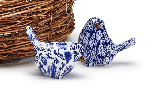 Two's Company Brand blue and white chinoiserie ceramic birds on a white background with a woven basket.