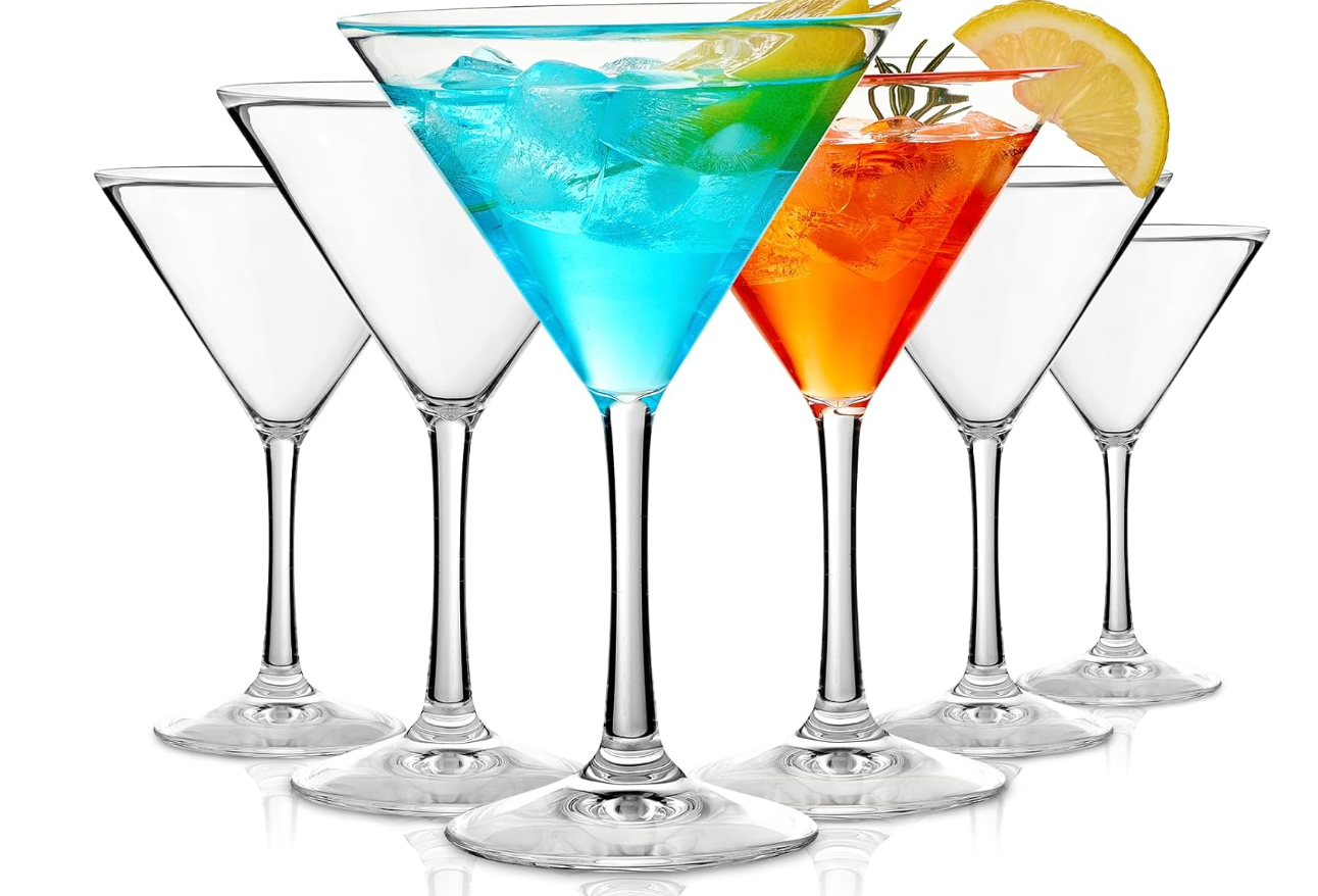 Six clear Huang brand Acrylic martini-style cocktail glasses arranged in a fan shape on a white background, with two glasses filled with colorful drinks and garnished with ice, lemon, and rosemary.