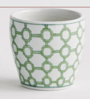 A Napa Home and Garden style white ceramic cup with a green geometric interlocking circle pattern, shown against a plain white background.