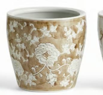 A napa Home and garden brand small ceramic cachepot with a brown and beige marbled glaze, decorated with white floral patterns, shown on a white background.