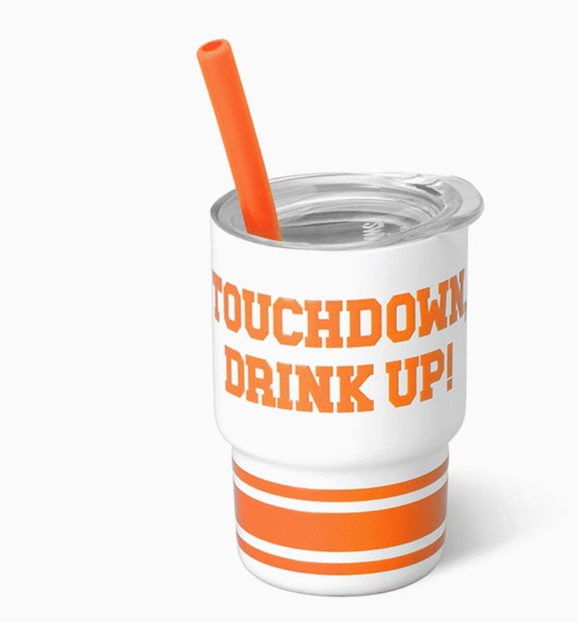 white and Orange shot glass tumbler with orange straw and Touchdown Drink Up on outside, on white background