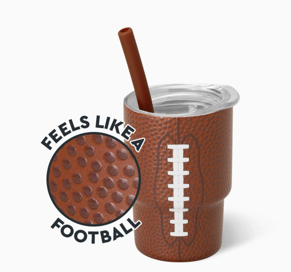 Brown football-themed shot glass with a straw and printed design on a white background