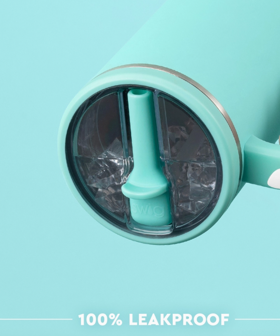 Lid of tumbler with aqua straw folded down on acrylic lid with aqua background, 