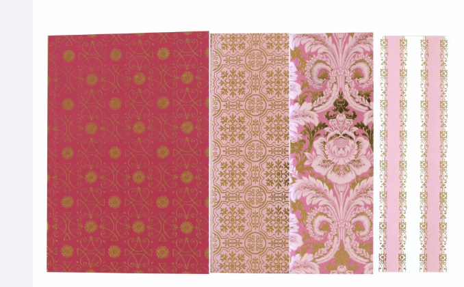 Four Anna Griffin Brand journal notebooks showing pink and gold decorative patterns, including floral, geometric, damask, and striped designs, displayed side by side on a white background.