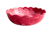 A Laura Park brand scalloped resin bowl with a marbled pink and white pattern, shown on a plain white background.