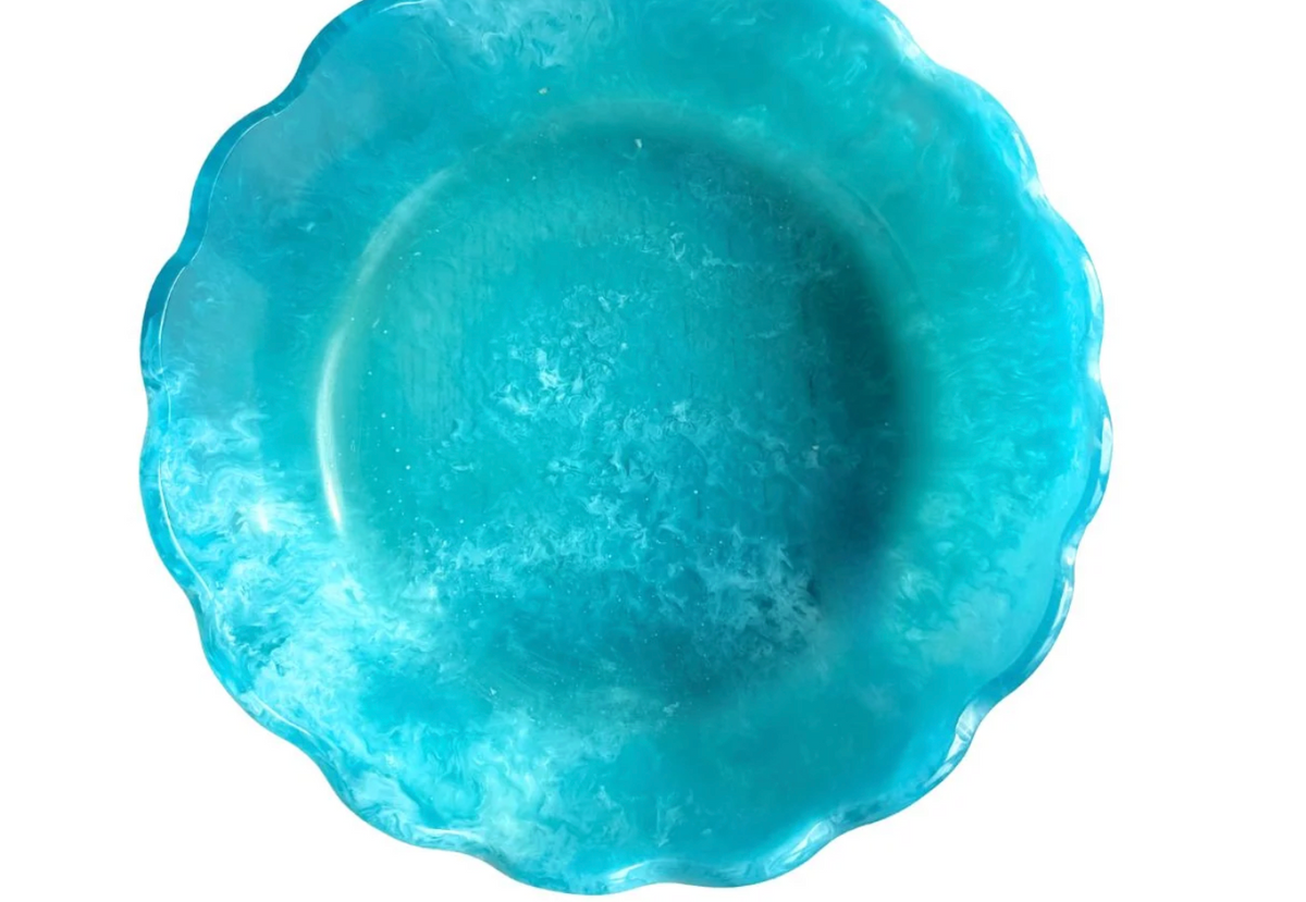 Top view of Laura Park Designs brand turquoise marbled resin bowl with scalloped edge on white background. 