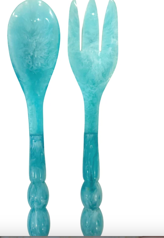 A turquoise blue marbled resin serving utensil set featuring a spoon and a three-tine serving fork, both with decorative beaded handles, shown against a plain white background.