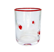 A clear glass tumbler with a red rim and red santa hat bubble details, shown on a plain white background.