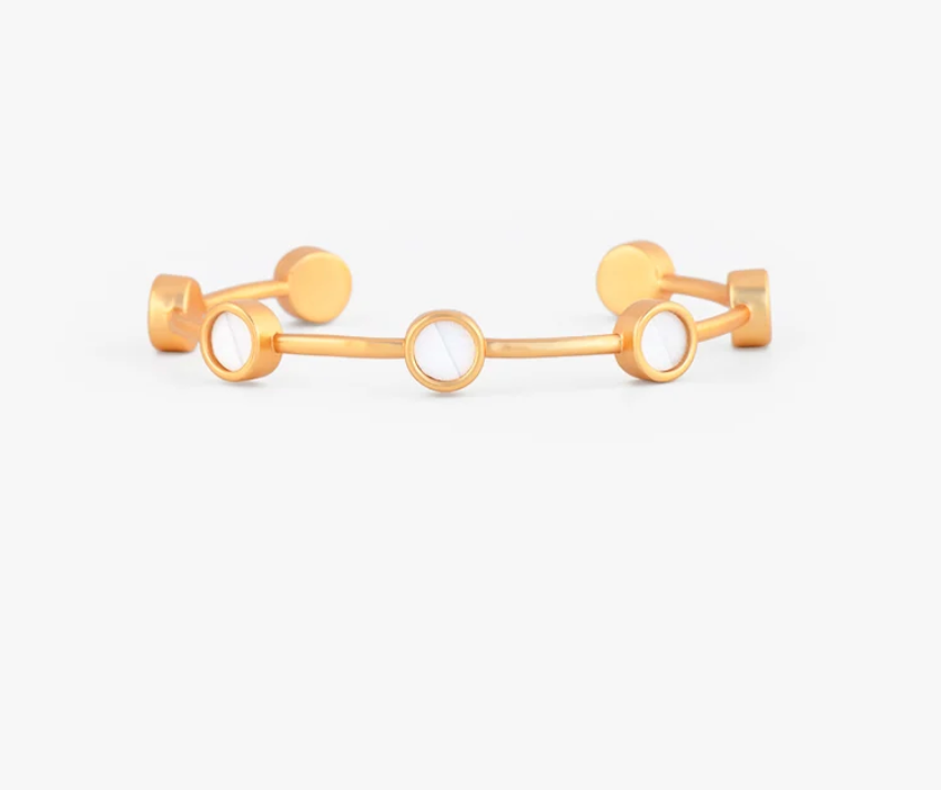 Gold cuff Brackish bracelet with round gold insets of white goose feathers