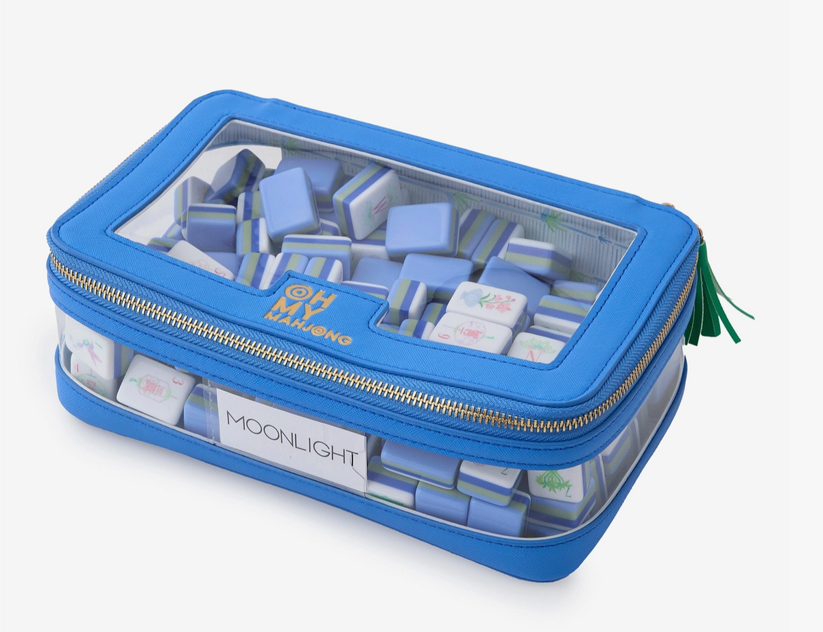 Bag with tiles: “Blue Mahjong tile storage bag filled with blue-and-white tiles visible through the clear top and side panels.”