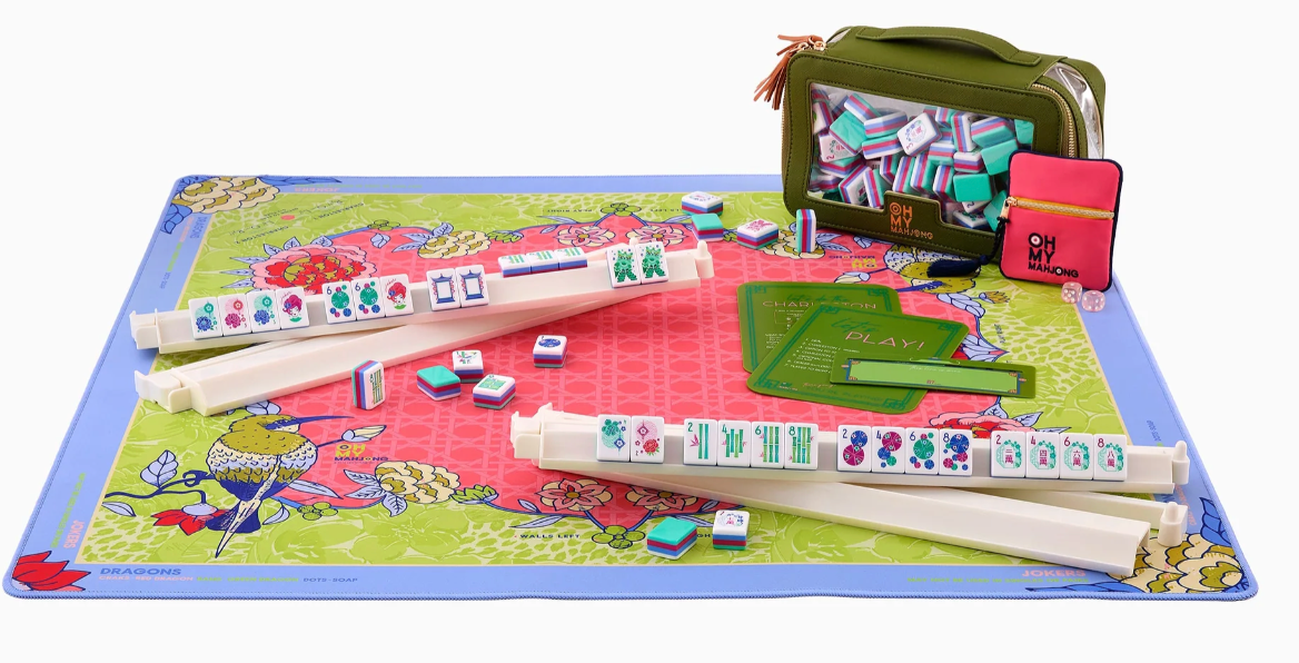 Oh My Mahjong Larkspur coral and green floral mat styled with Mahjong tiles, ivory racks, and coordinating accessories.⠋
