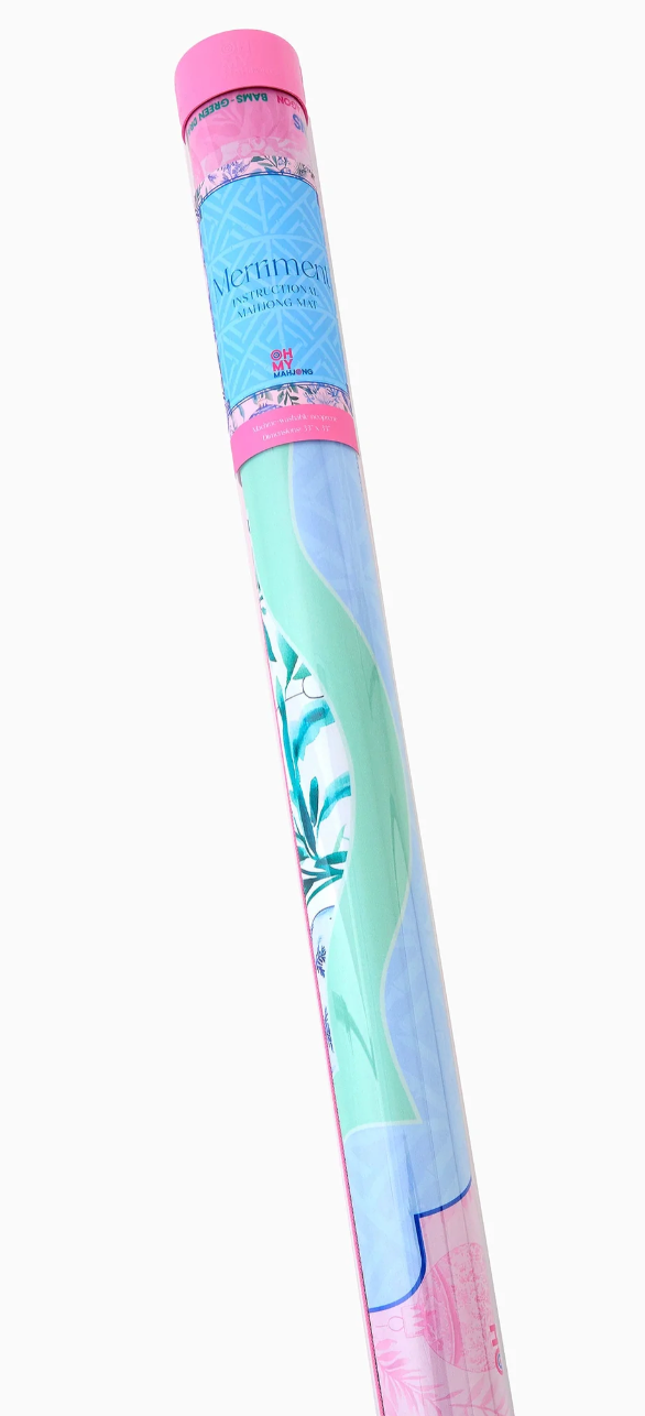 Oh My Mahjong Merriment mat rolled inside its clear storage tube with a pink cap and blue label.