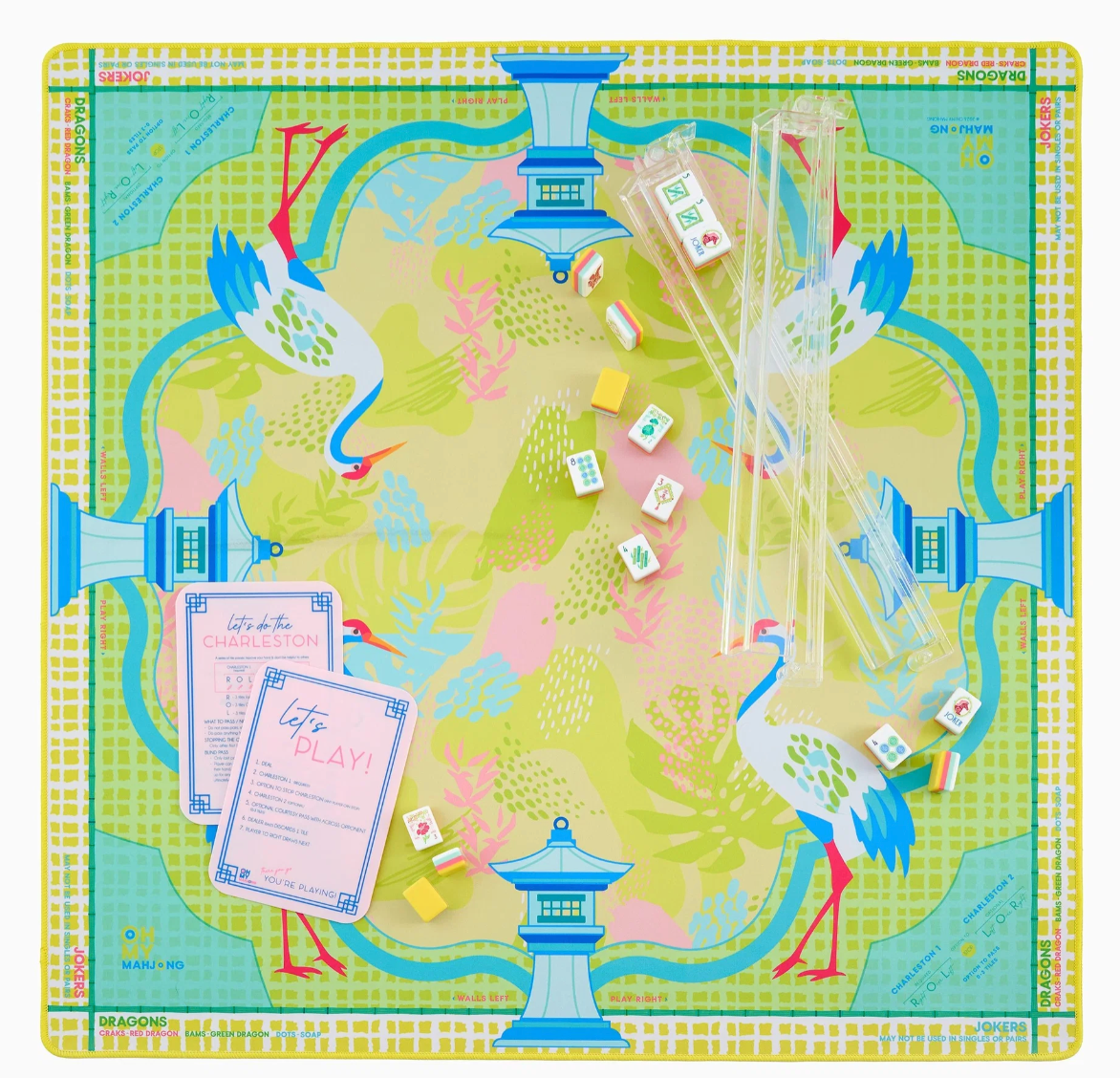 Overhead view of the Oh My Mahjong Hampton crane mat with clear racks, scattered tiles, and pink reference cards.