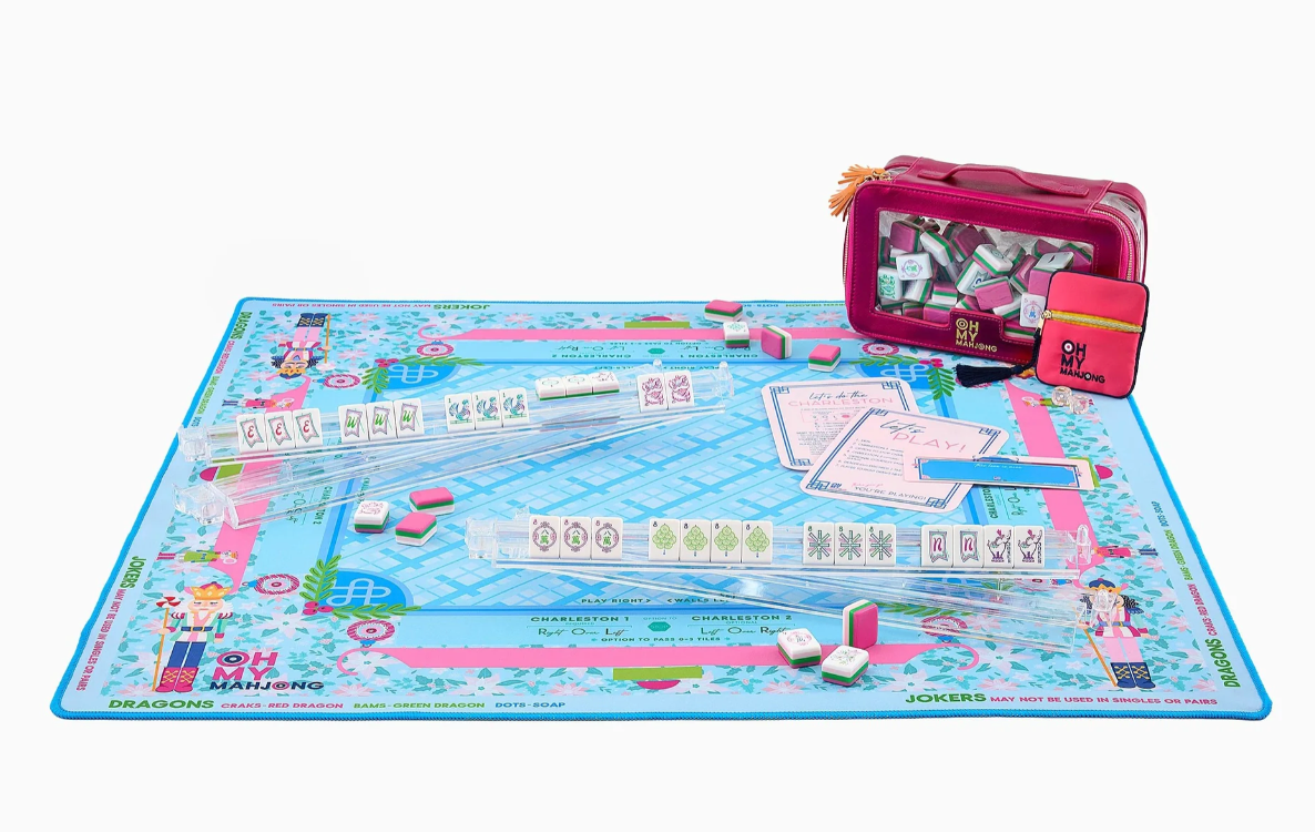 Oh My Mahjong Sugarplum nutcracker mat set up with clear racks, tiles, reference cards, and a deep pink tile bag.