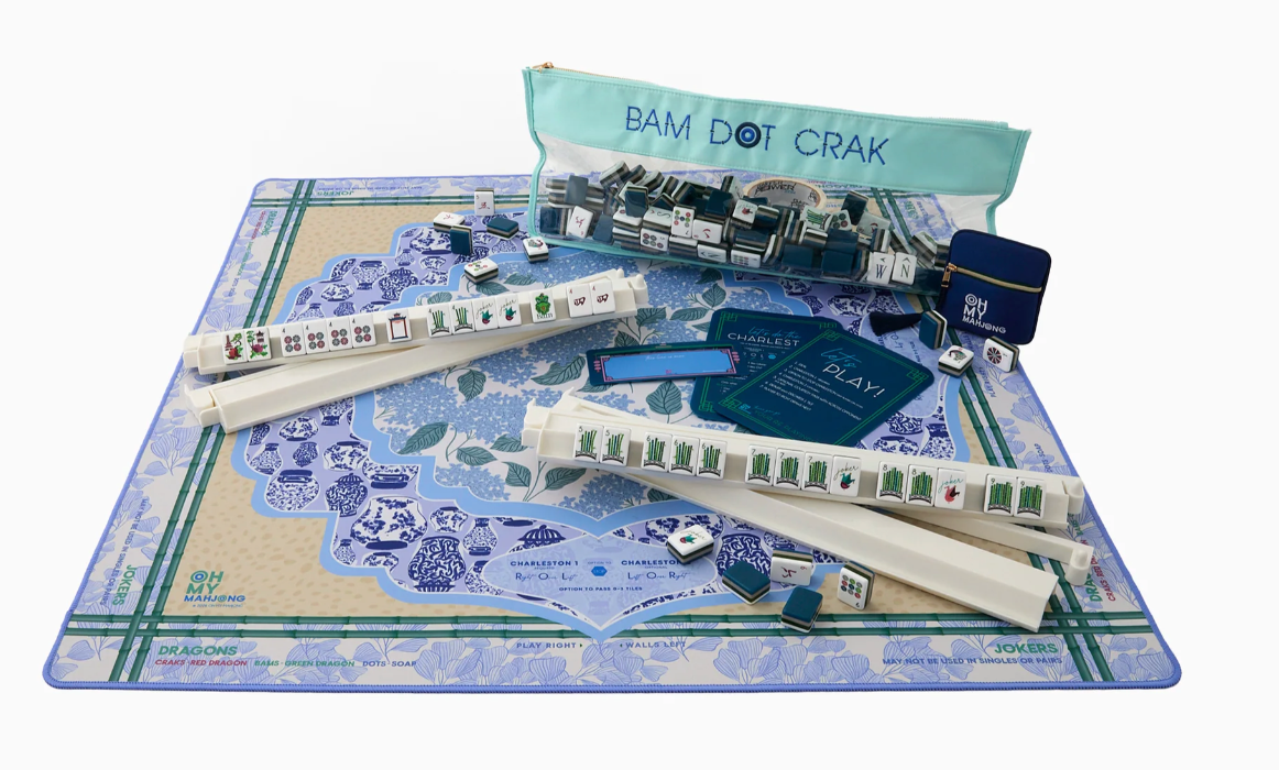 Oh My Mahjong Luna mat set up with ivory racks, tiles, navy reference cards, and a mint-green tile bag.
