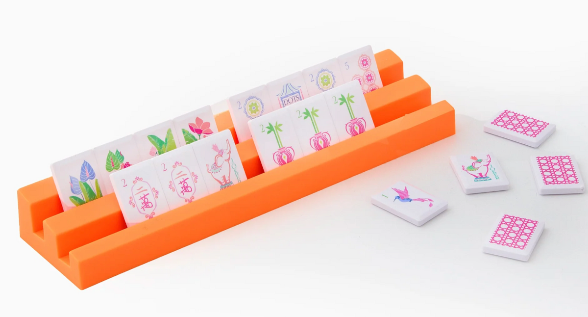 Oh My Mahjong Poppy Debutante tiles displayed on bright orange double racks, with loose tiles showing pink patterned backs.