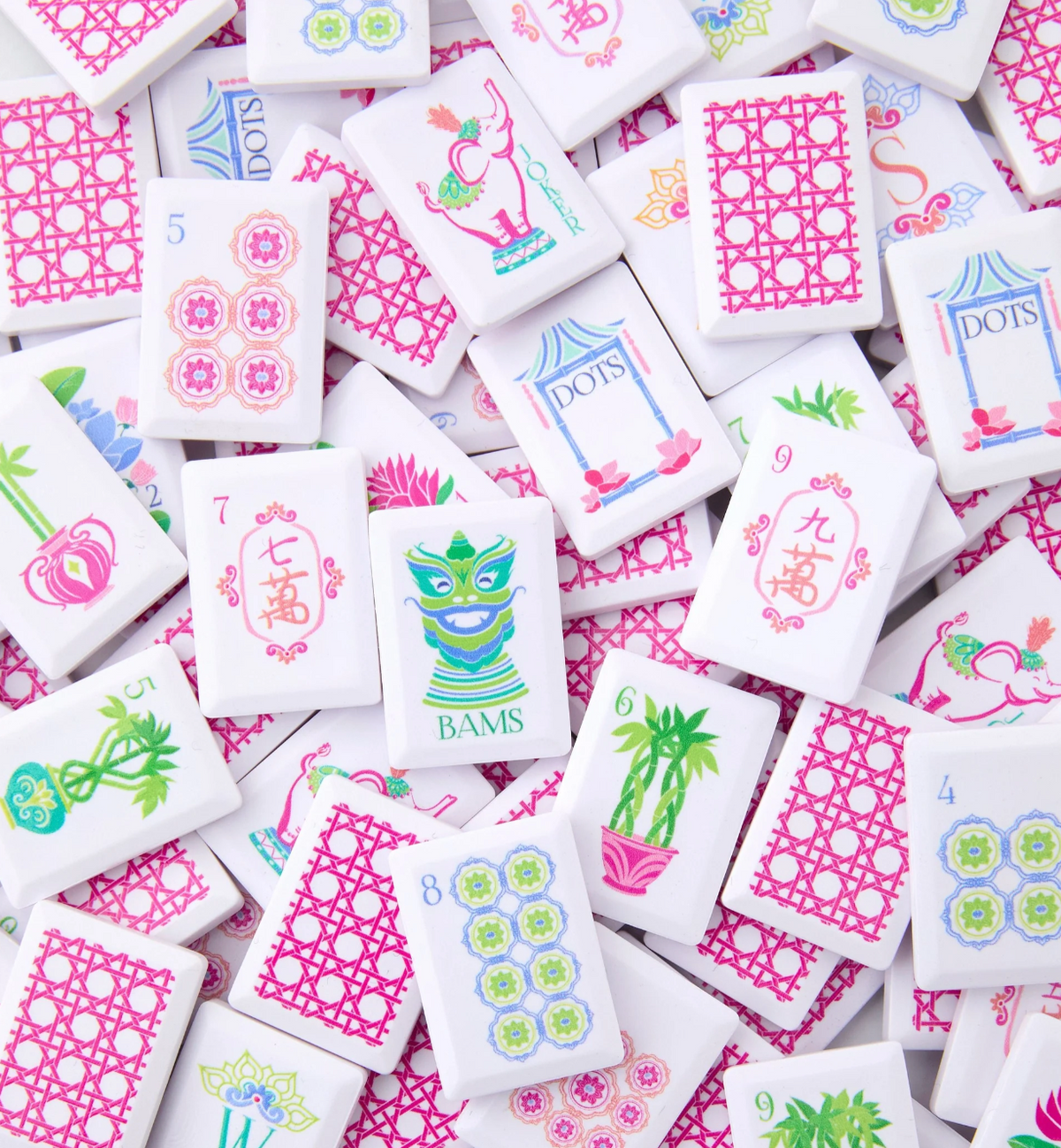 Close-up of scattered Oh My Mahjong Poppy Debutante tiles with pink lattice backs and colorful illustrated white faces.