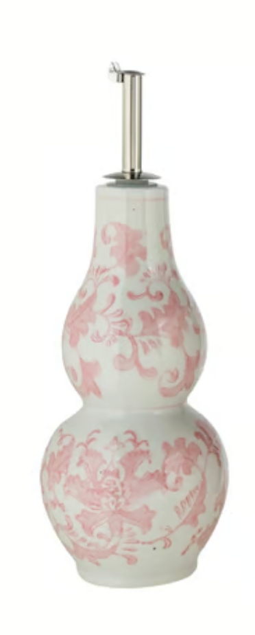 Hand-painted stoneware oil cruet with pink-and-white floral pattern, double-gourd] body, and stainless steel pour spout.”