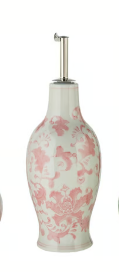 Hand-painted stoneware oil cruet with pink-and-white floral pattern, oval body, and stainless steel pour spout.