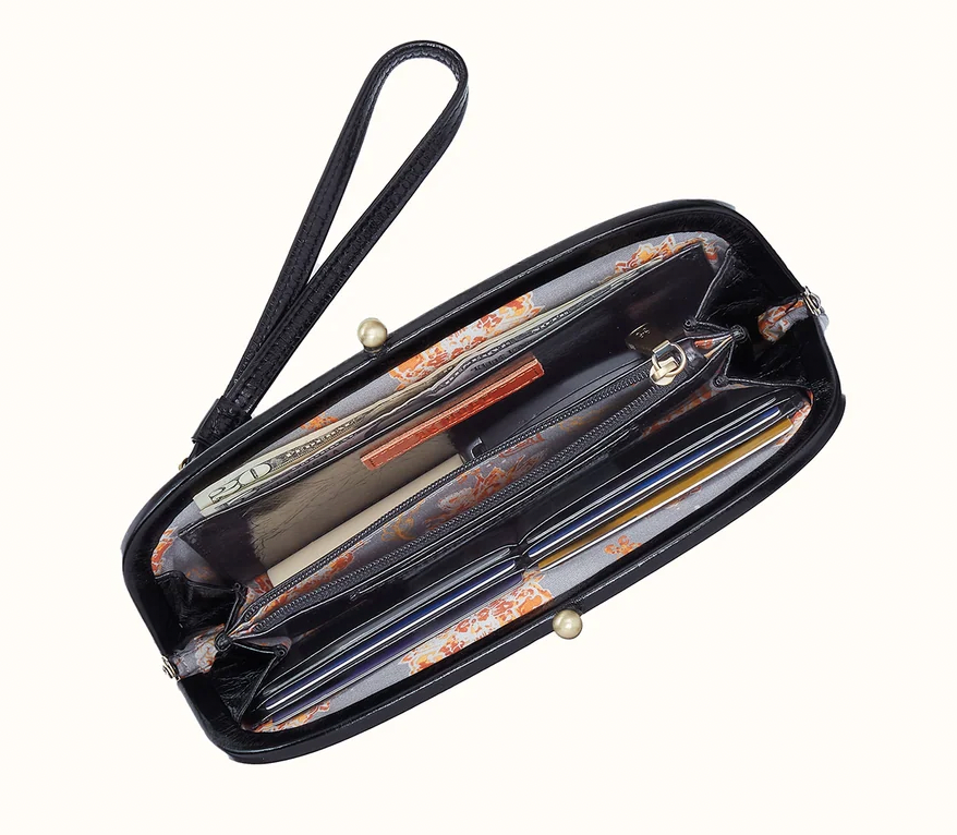 Hobo BRAND Alba black frame wallet open to show floral lining, six card slots, bill compartments, and a center zipper pocket.