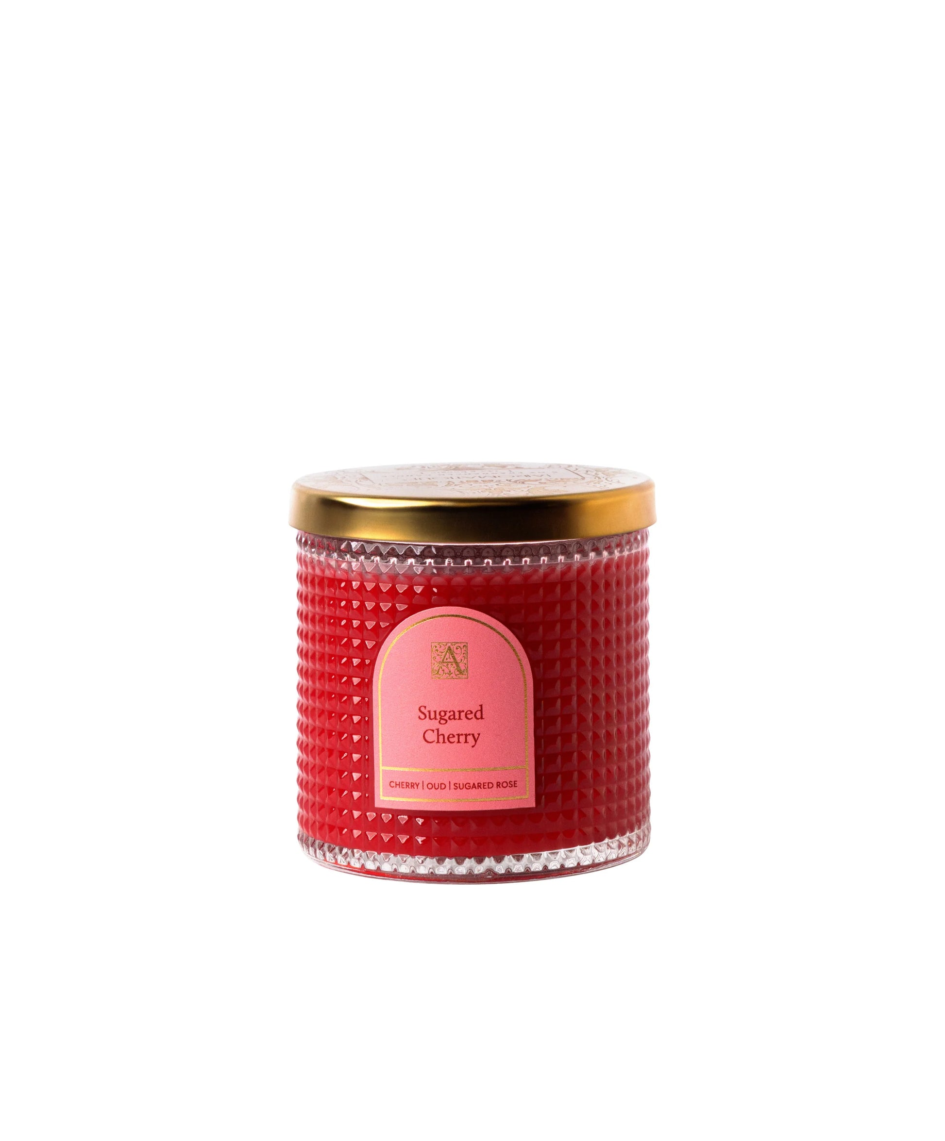 Red candle with a gold lid and pink label on a white background