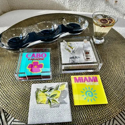 Coasters - Cabo Paradise - Acrylic - set of 4 - sitting on coffee table with other accessories 