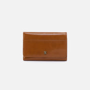 Brown leather wallet with a decorative clasp on a white background
