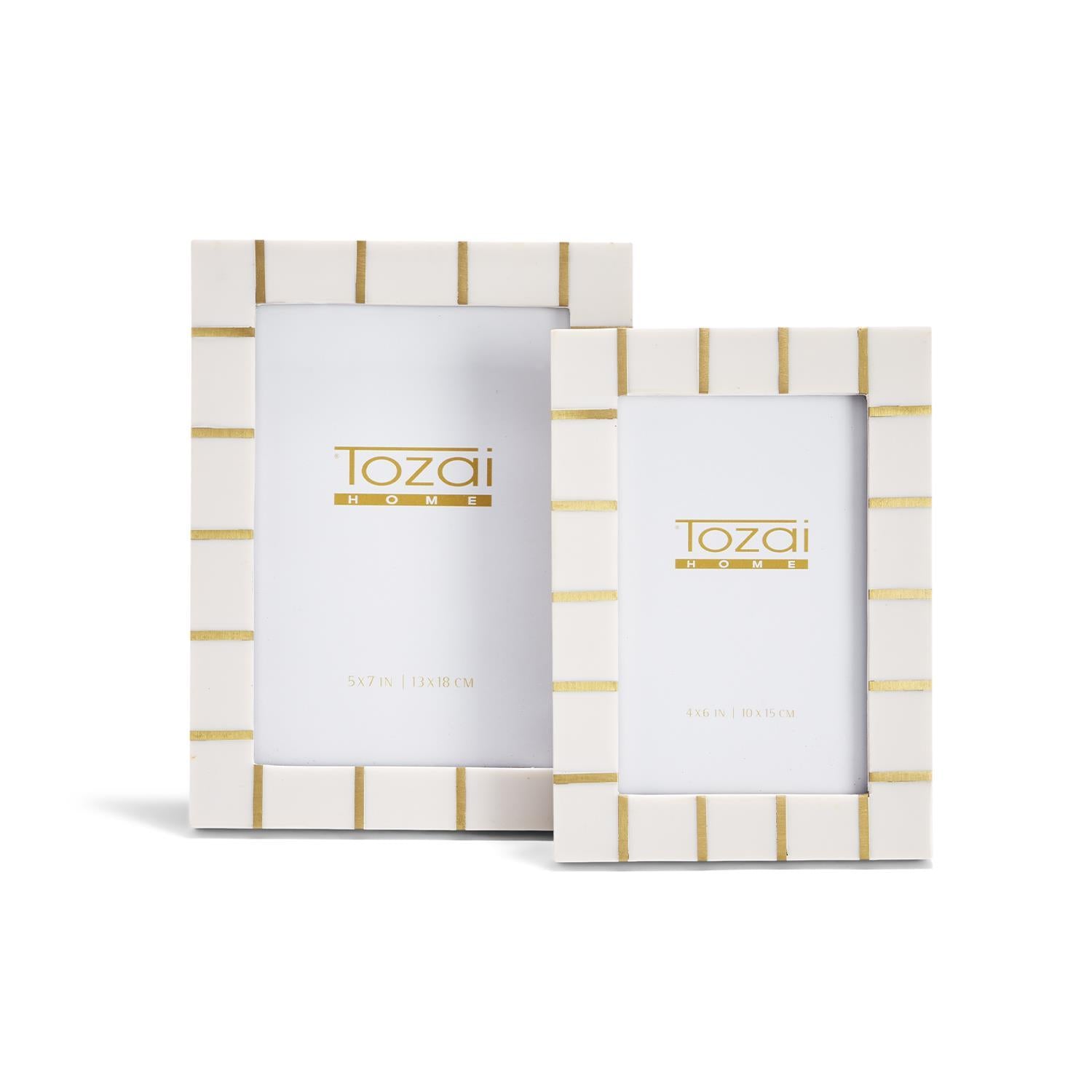 Two white photo frames with gold accents and 'Tozai' branding on a white background.