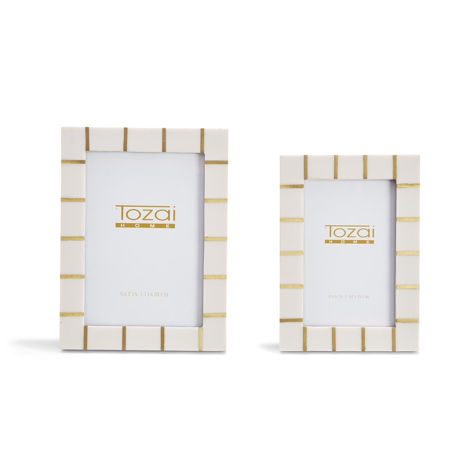 Two photo frames with gold accents on a white background, featuring the brand 'Tozai'.