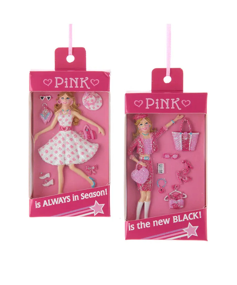 Two packaging designs for dolls with pink and black text on a white background