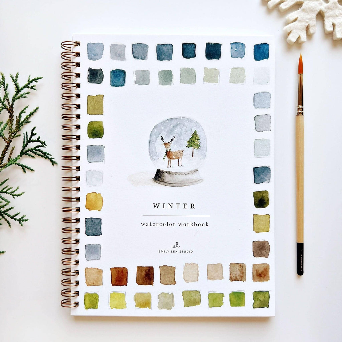 Winter watercolor workbook with a snow globe design on a white background