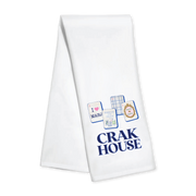A Toss designs white kitchen towel with blue printed graphics and the text 'CRAK HOUSE' on a plain white background.ns 