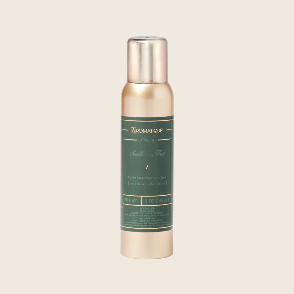 Gold and green bottle with a label on a beige background