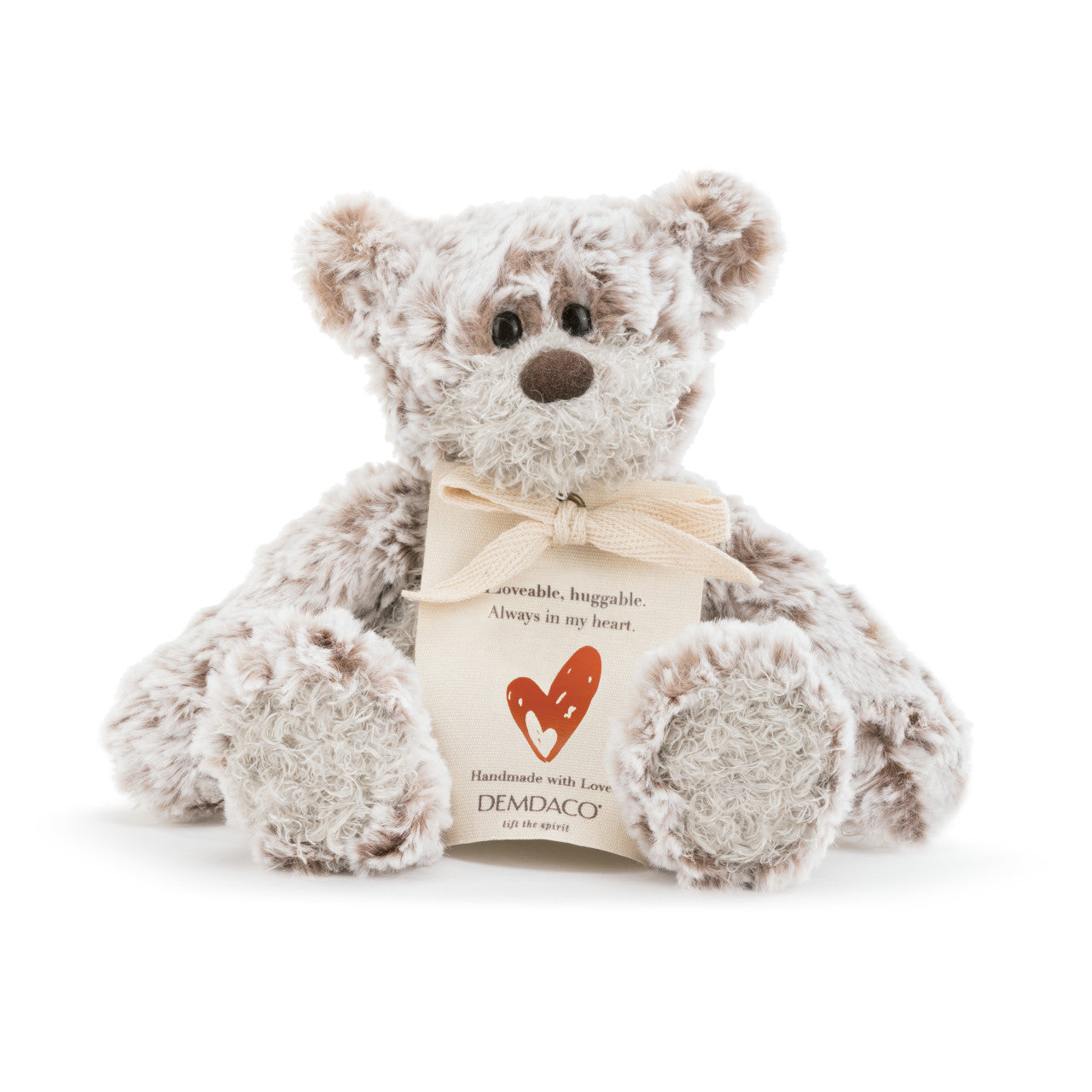Plush teddy bear with a heart-shaped tag on a white background