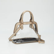 Clear handbag with gold straps on a white background