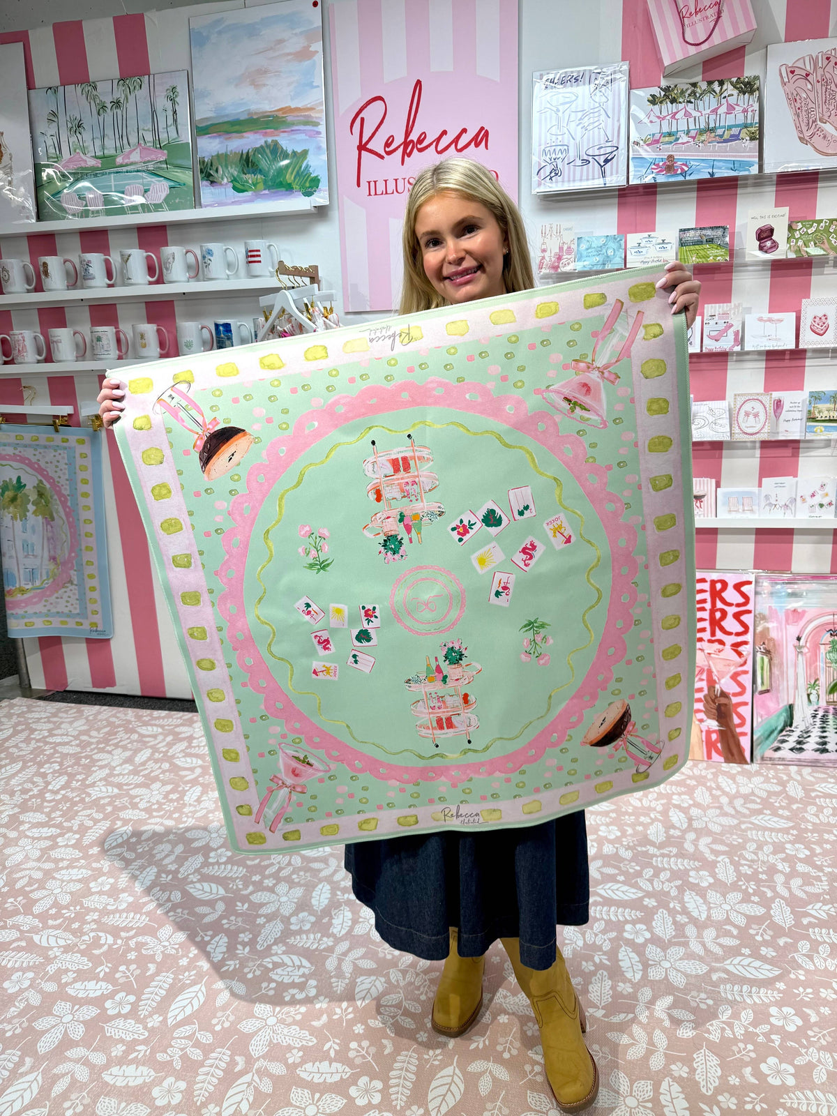 woman holding a 32 x 32 in. pink and green mahjong mat for game night and table decor