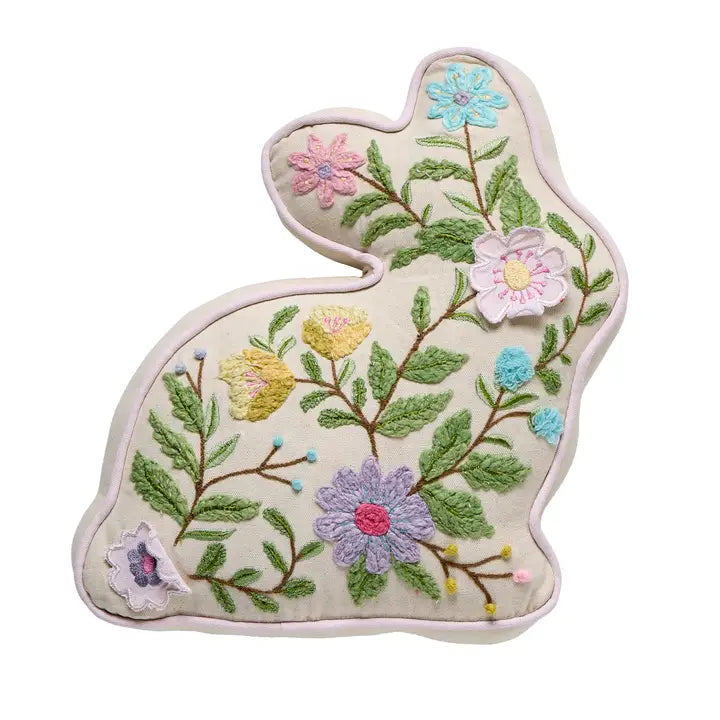 Embroidered bunny-shaped pillow with floral designs on a white background